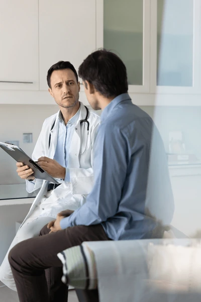 focused concerned doctor examining male 600nw 2566357853